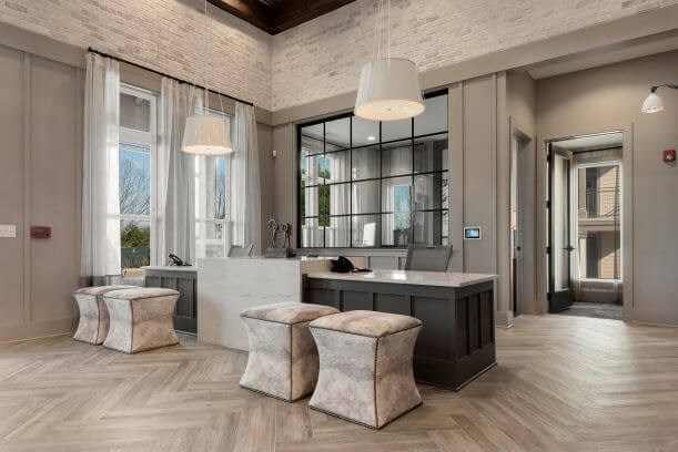 A modern bathroom with a large mirror and a vanity.