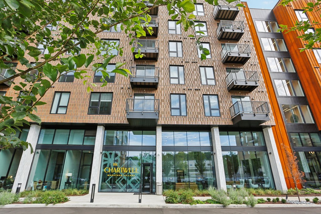 A modern building with a glass entrance and a sign that reads "CHARLEW".