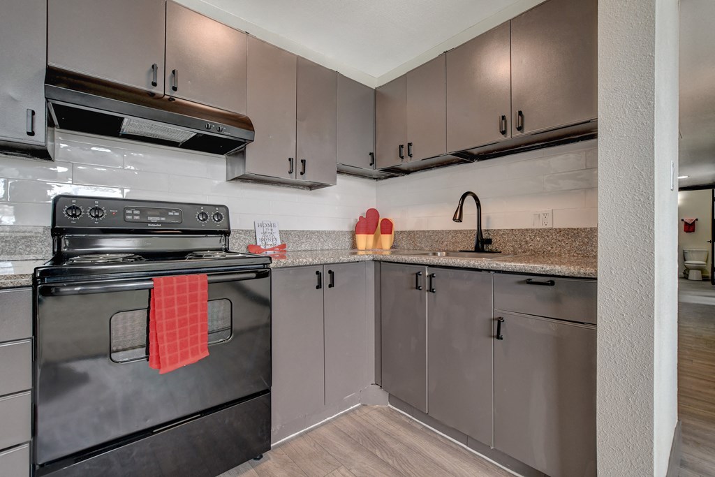 a kitchen with stainless steel appliances and granite counter tops
