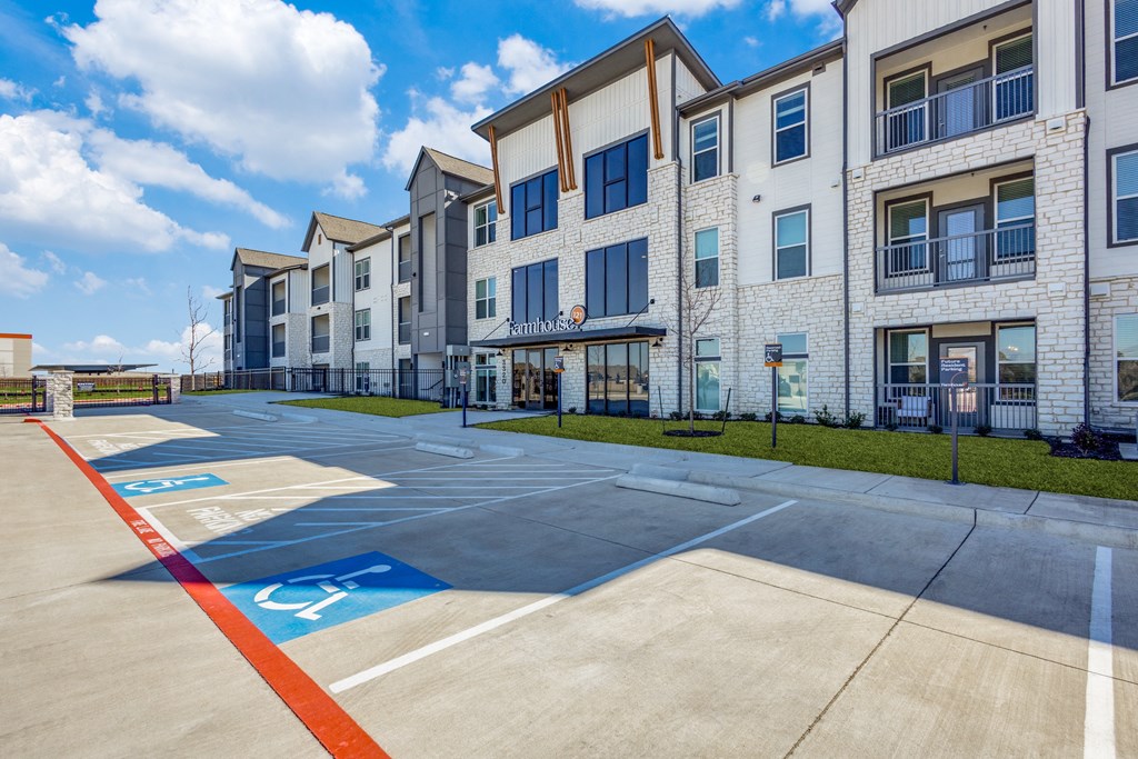 an empty parking lot in front of an apartment building