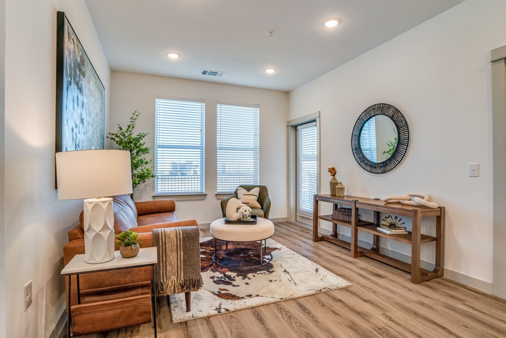 A living room with a white couch, a white lamp, and a white coffee table.