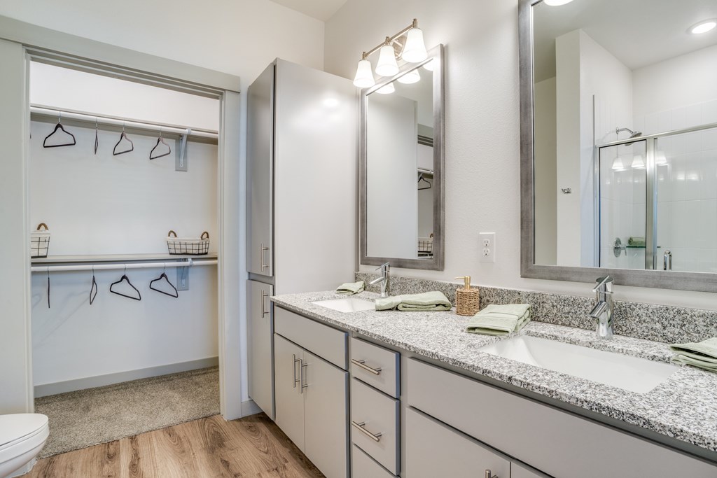 A bathroom with a sink, mirror, and a white door.