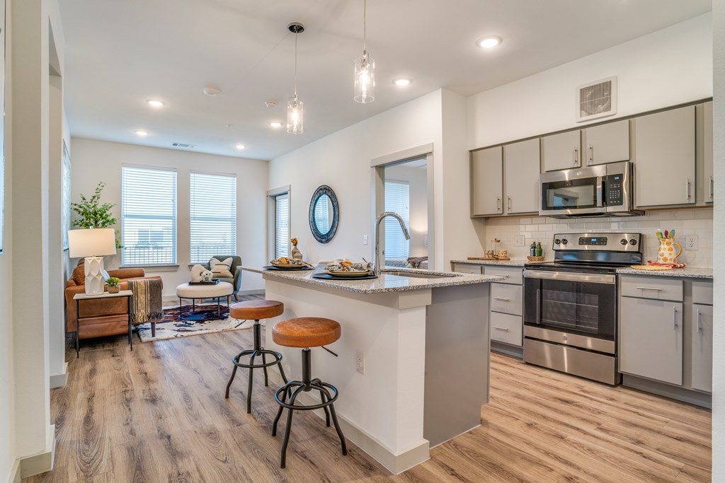A modern kitchen with a bar stool and a countertop.