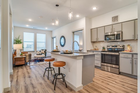 A modern kitchen with a bar stool and a countertop.