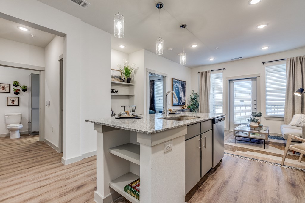 an open floor plan with an island kitchen and living room