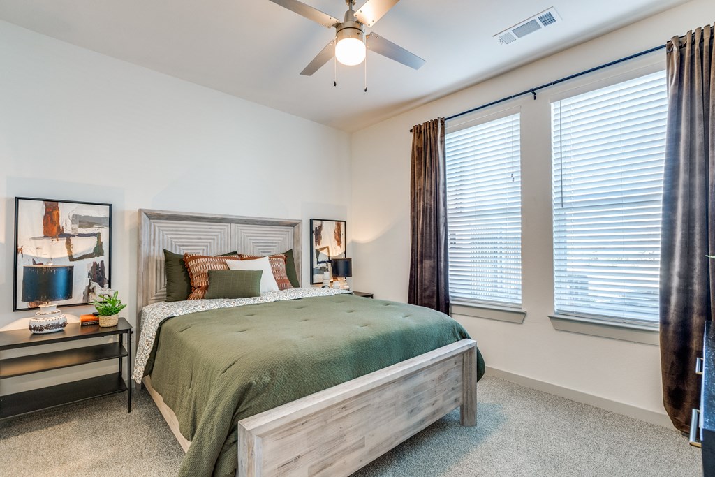 a bedroom with a bed and a ceiling fan