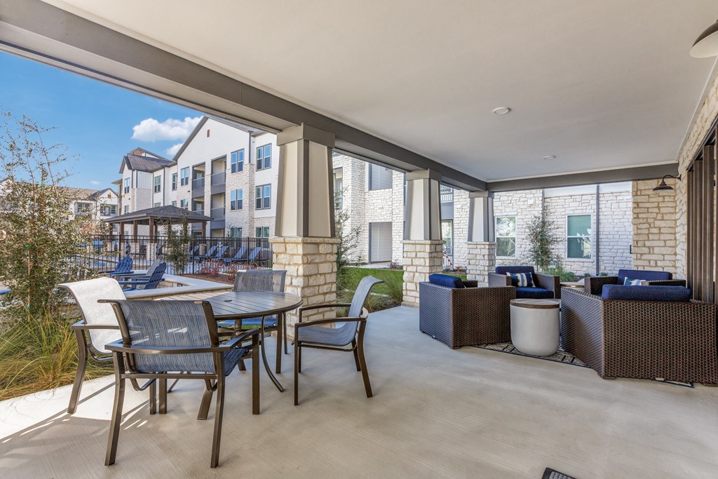 a living room with a patio and a table and chairs