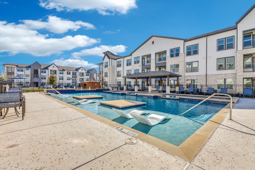 our apartments have a resort style pool with seating and tables