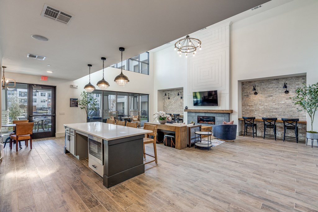 the preserve at ballantyne commons clubhouse with an open floor plan and a fireplace