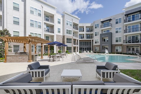 Relaxing pool with outdoor grilling area.
