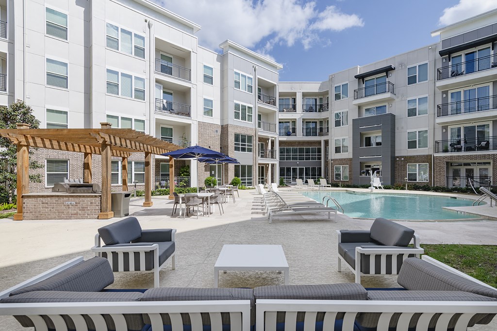 Relaxing pool with outdoor grilling area.