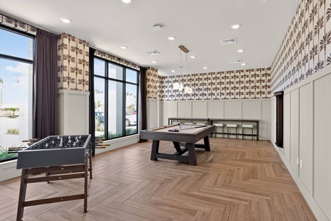 A room with a pool table and a shelf.