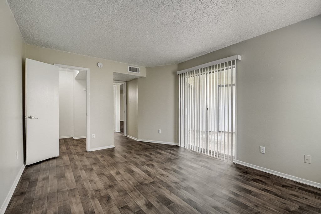 an empty living room with a hardwood floor