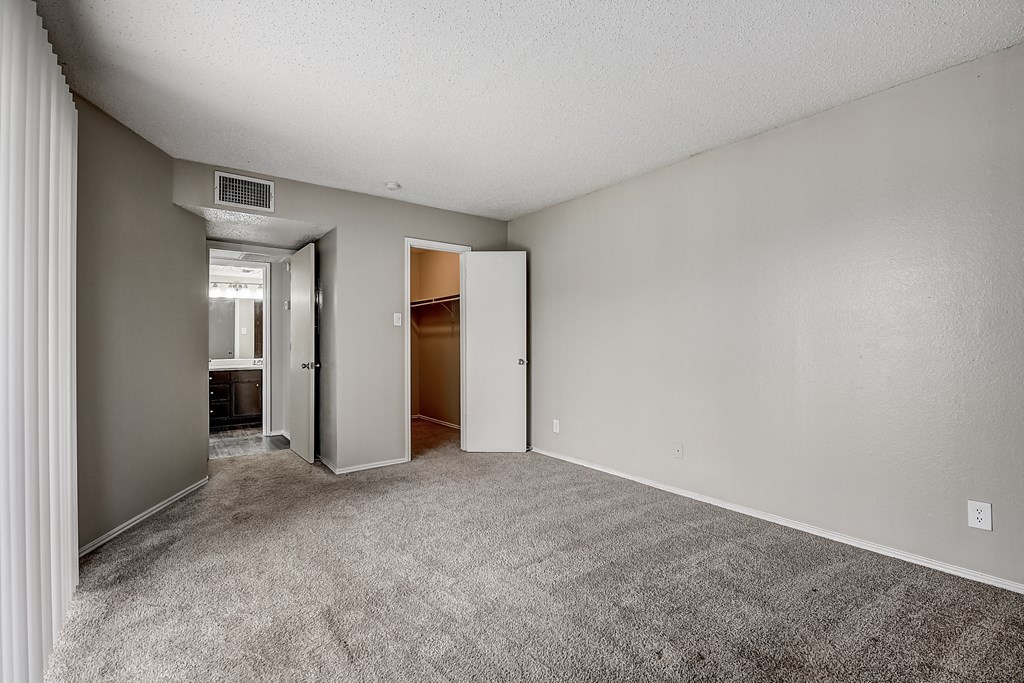a bedroom with gray carpet and white walls