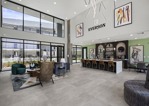the lobby of a building with a bar and chairs