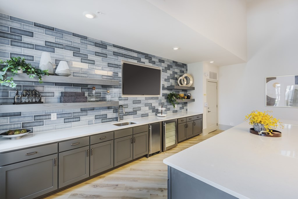 A modern kitchen with a grey and white color scheme.