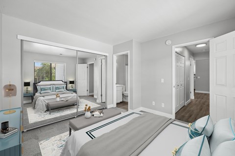 A bedroom with a large bed and a mirrored wall.