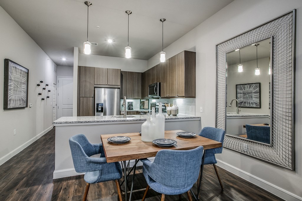 a dining room and kitchen with a table and chairs