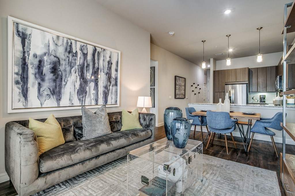 a living room with a couch and a glass table