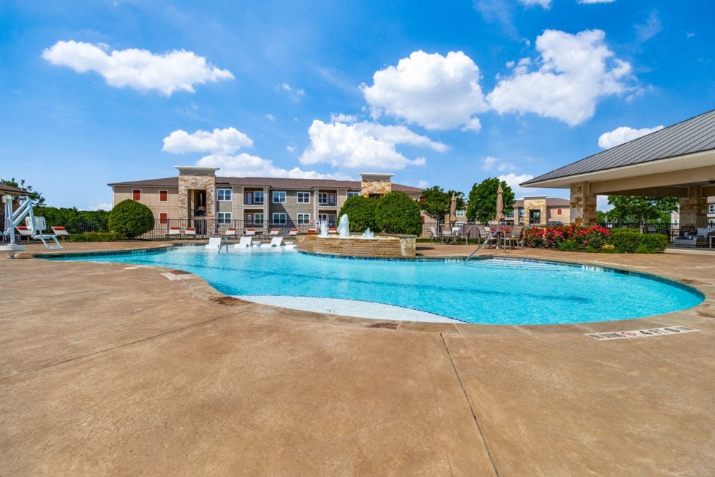 a swimming pool with a building in the background
