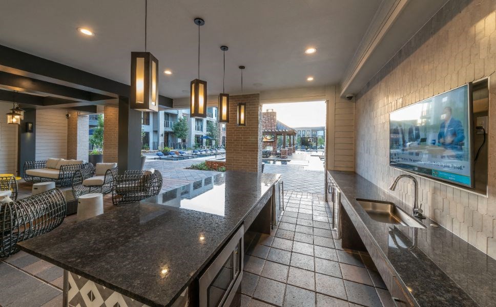 a large kitchen with a counter top and a sink