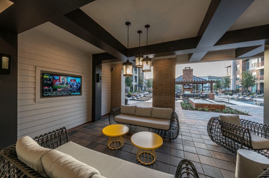 a living room with couches and tables and a television