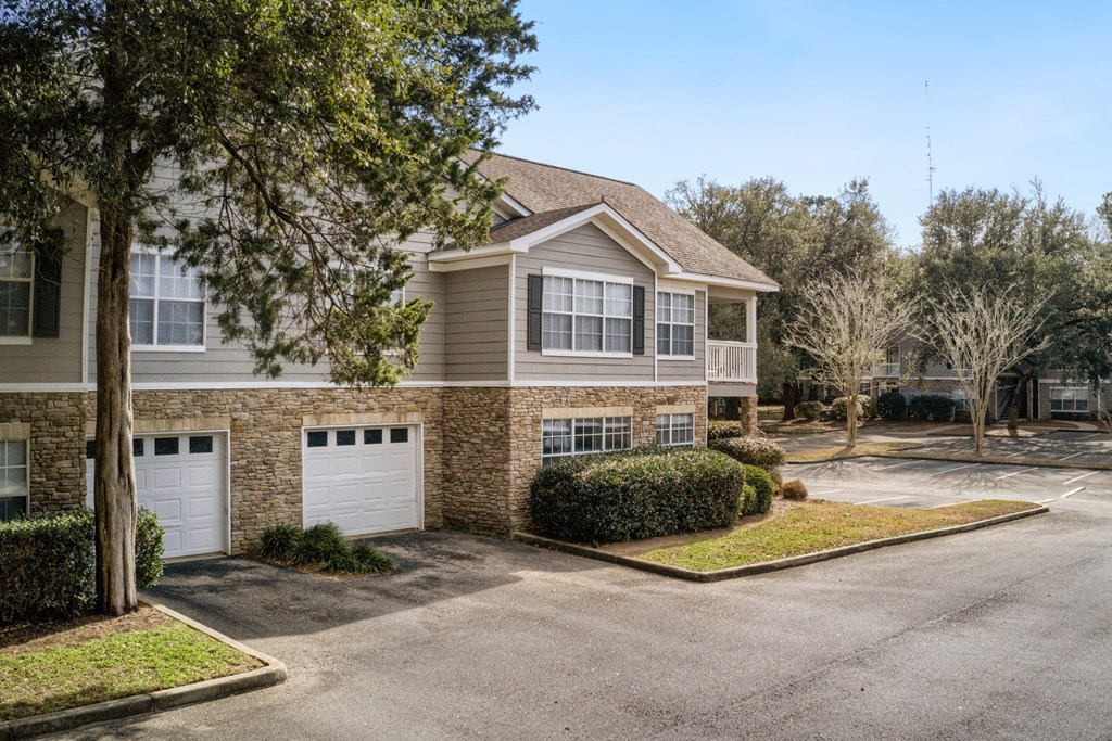 a house with two garage doors in front of it