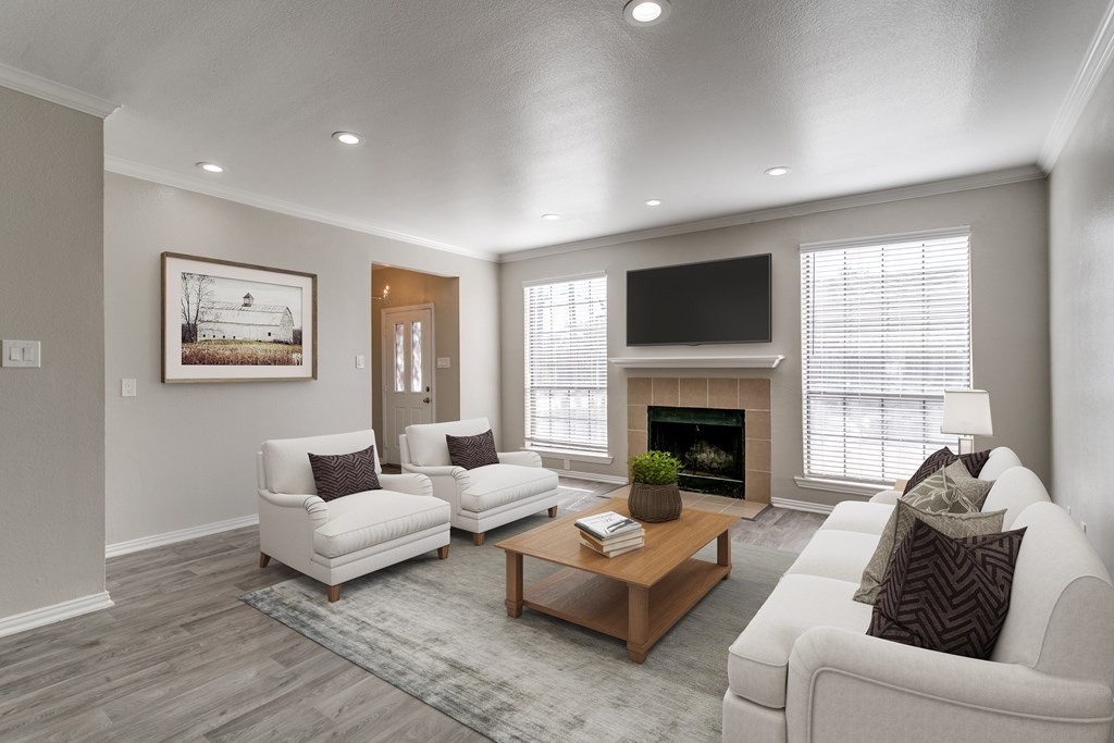 A living room with a fireplace and a painting on the wall.