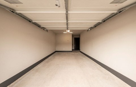 a large empty room with white walls and a concrete floor