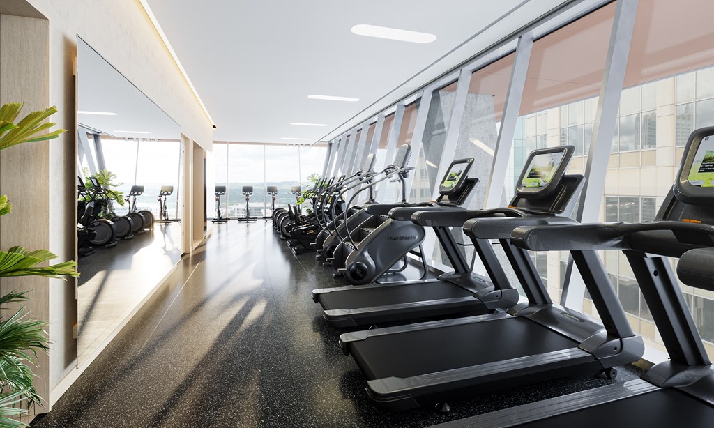 a row of treadmills in a gym with a large window
