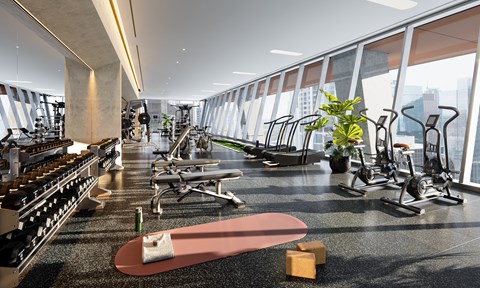 a gym with weights and cardio equipment and a skateboard on the floor