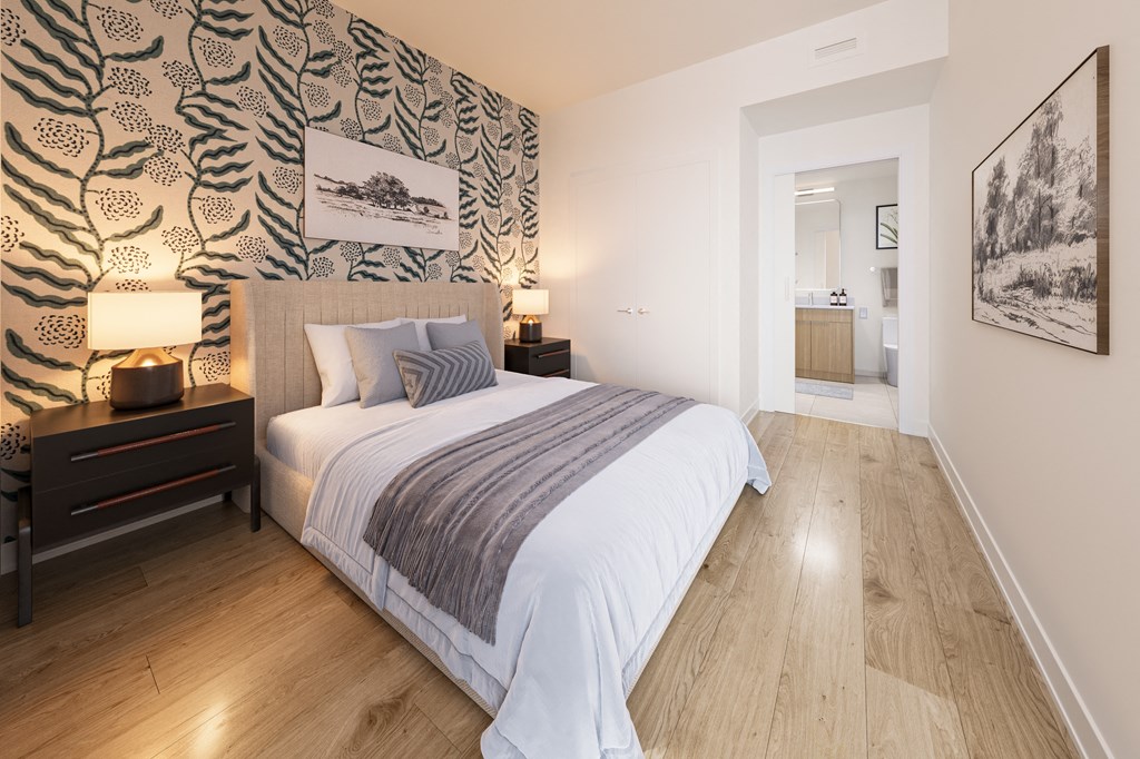 a bedroom with a large bed and a wallpaper on the wall