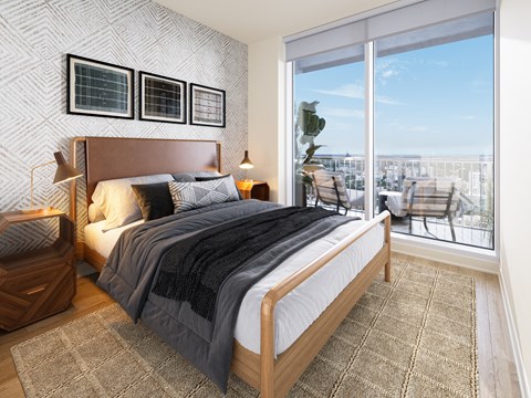 A bedroom with a large bed and a view of the city.
