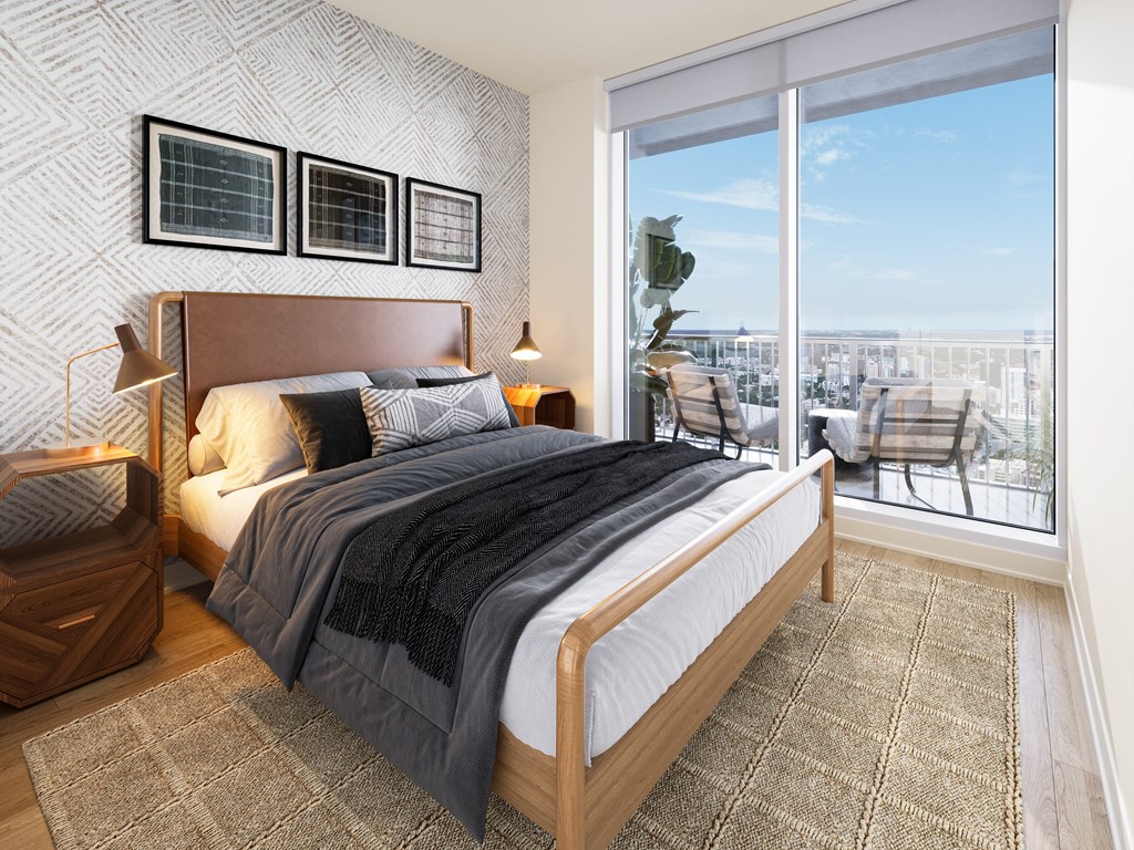 a bedroom with a bed and a large window