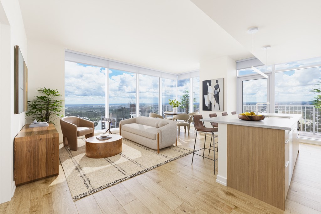 an open floorplan living room and kitchen with a view of the city