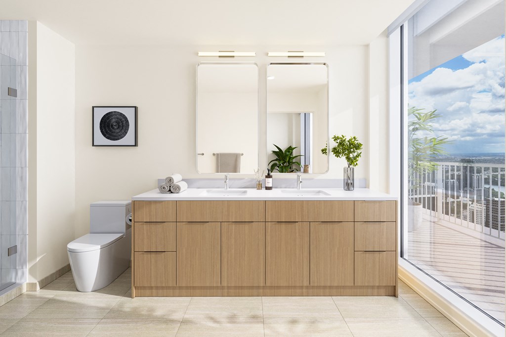 a bathroom with a sink and a toilet and a window