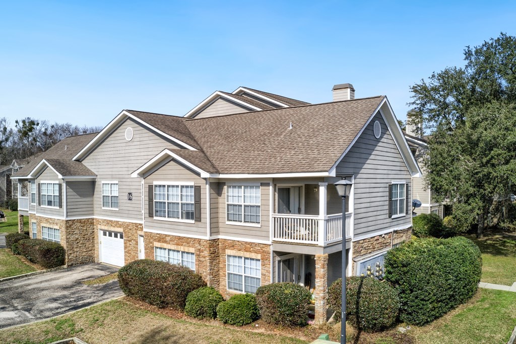 a large house with a porch and a street in front of it