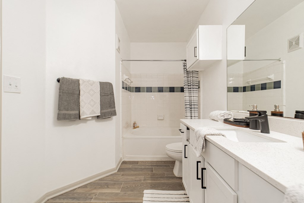 a small bathroom with a shower and a sink and a toilet