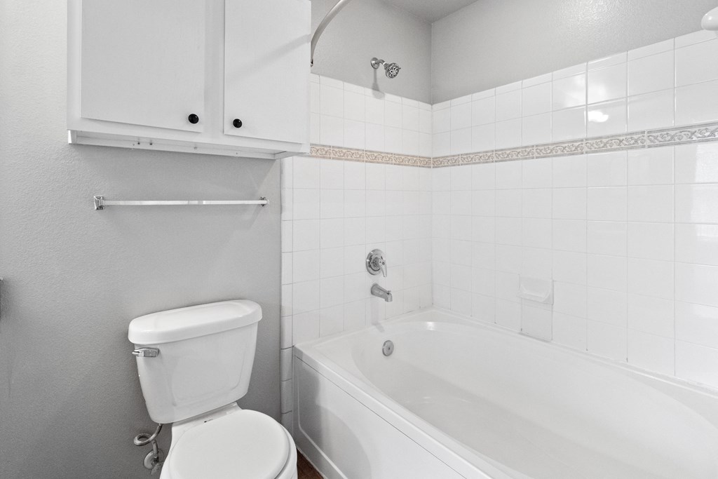 an empty bathroom with a toilet and a bath tub