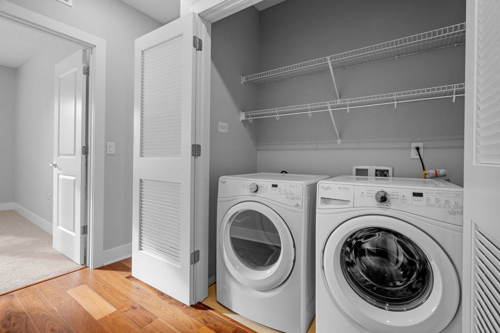 a washer and dryer in a laundry room with a closet