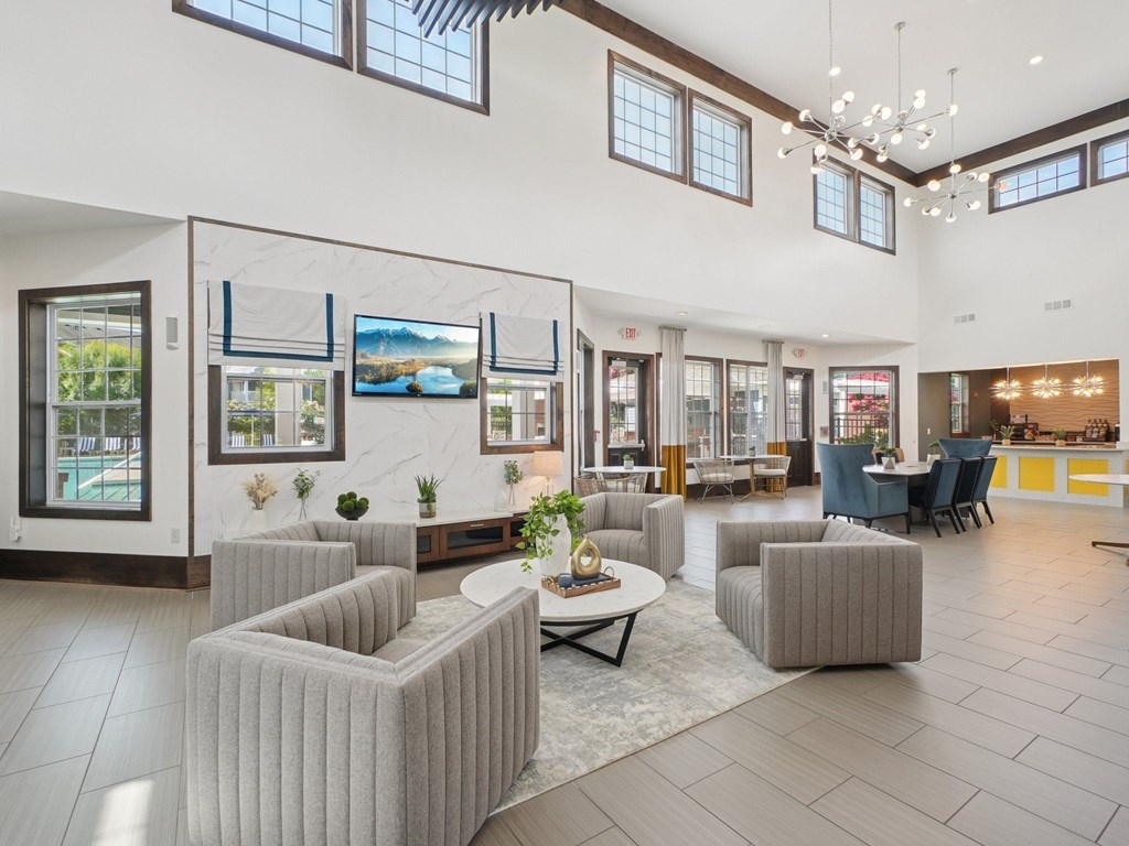 A spacious lobby with grey couches and a coffee table.