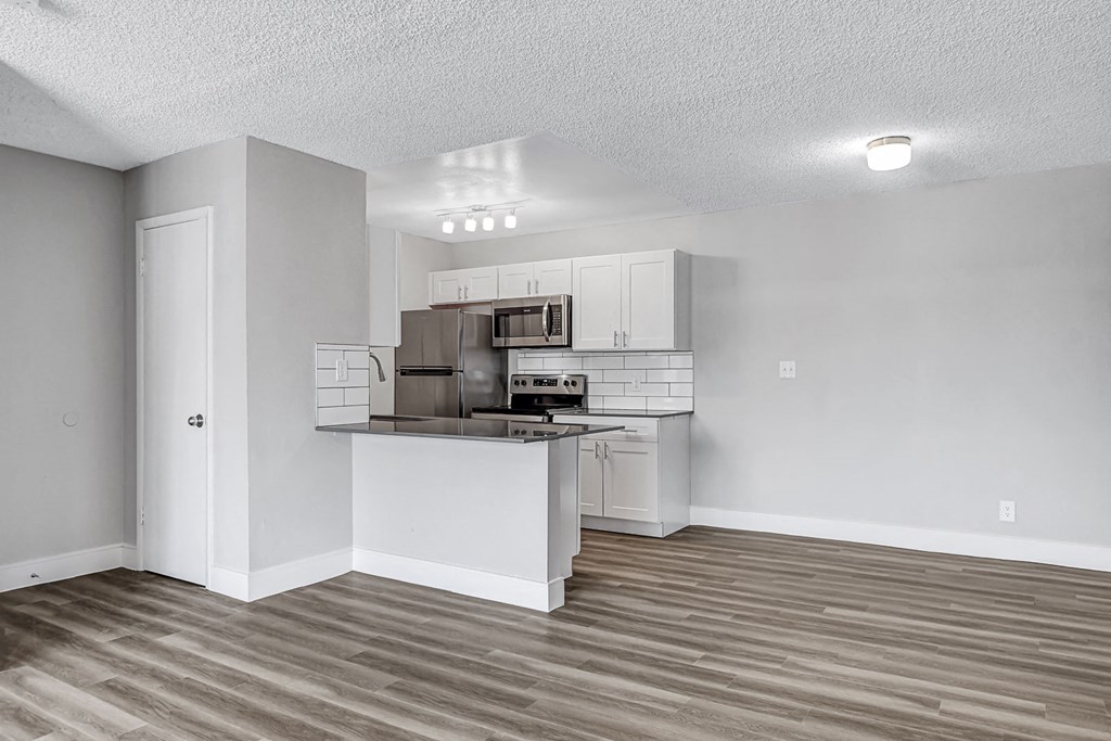 an open kitchen with an island and stainless steel appliances