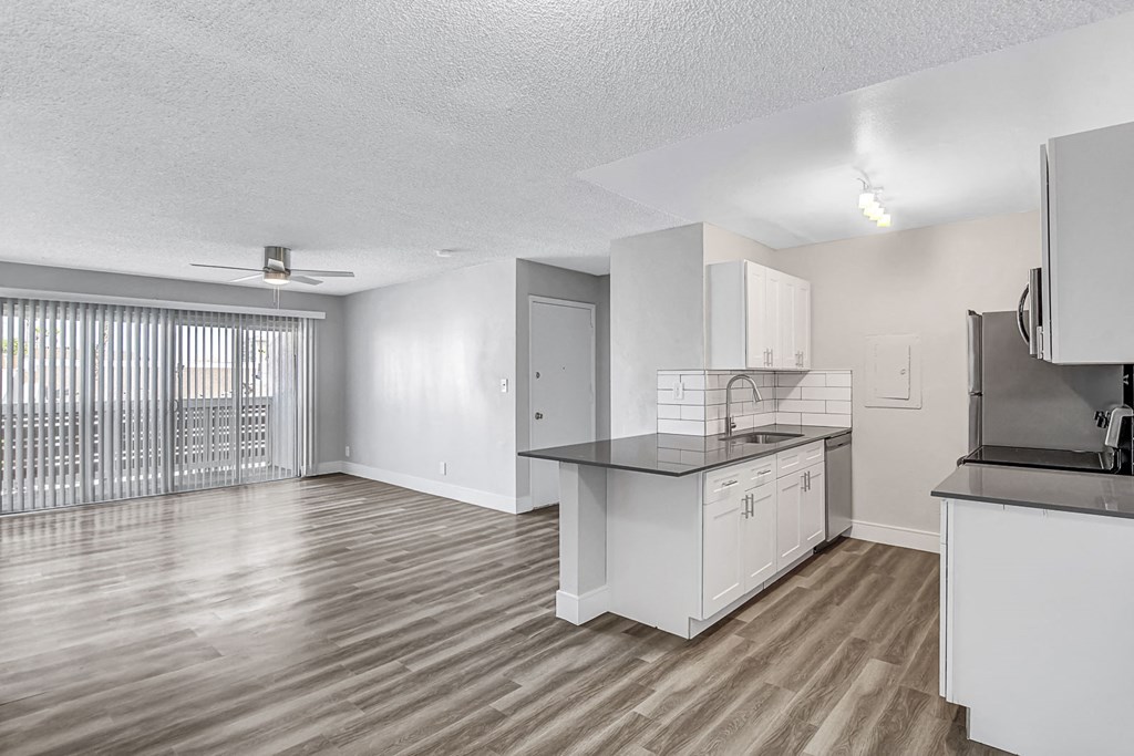 a kitchen and living room with a large window