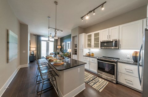 a kitchen with white cabinets and a counter top