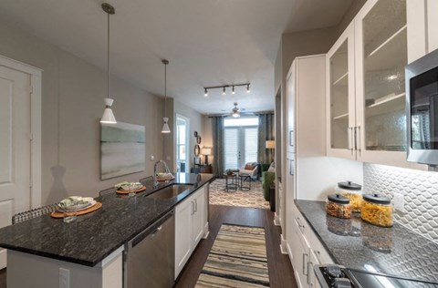 a kitchen with a counter top and a living room