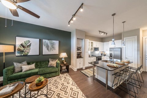 a living room with a kitchen and a dining room table