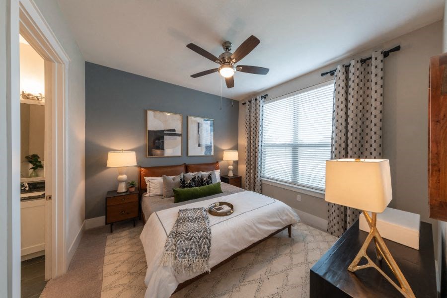 a bedroom with a bed and a ceiling fan