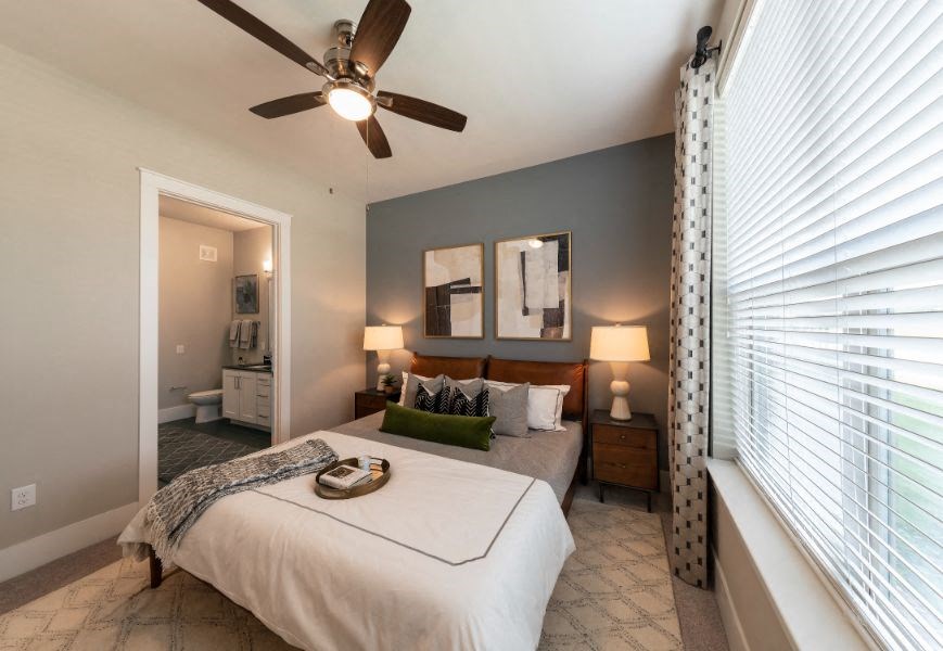 a bedroom with a bed and a ceiling fan