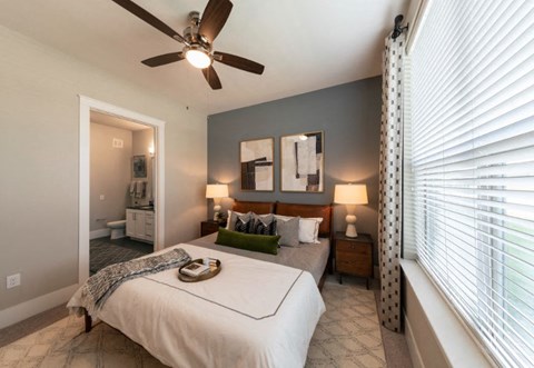 a bedroom with a bed and a ceiling fan