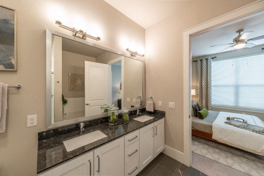 a bathroom with two sinks and a large mirror